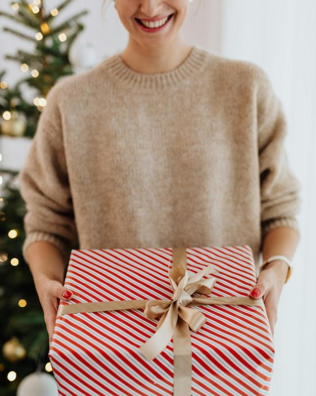 Woman receives a red and white wrapped gift